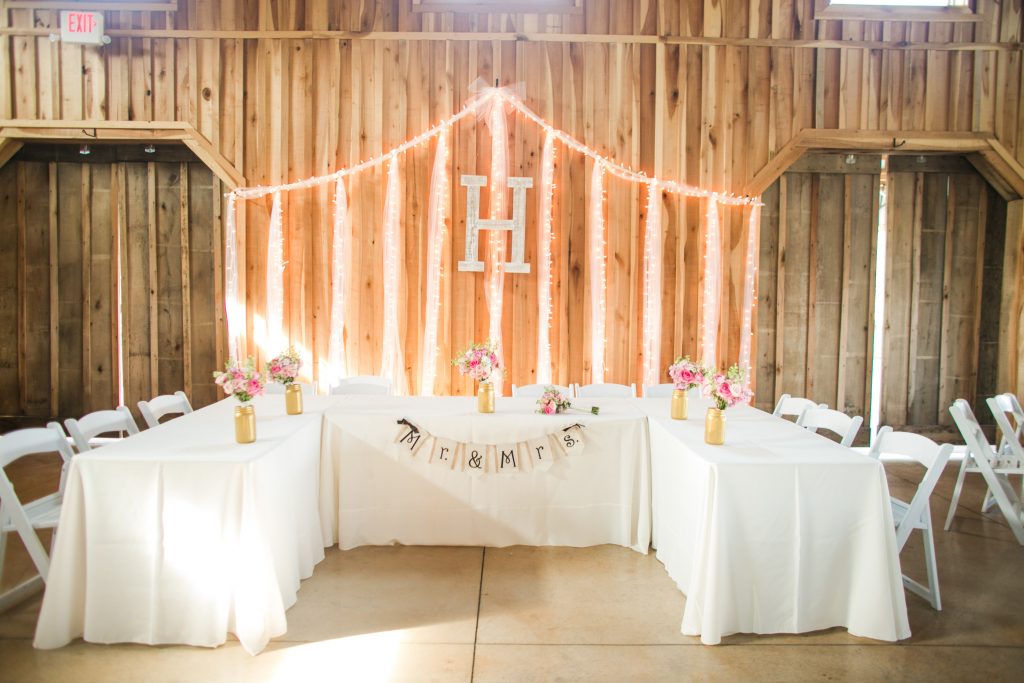 Rustic barn wedding meets vintage fairy tale. Meadow Creek Farm North Alabama wedding venue. Vintage Beauty and the Beast inspired wedding reception decoration ideas. Lace, mermaid style wedding gown. Half up curly bridal hair with braids. Pink and white bridal bouquet.