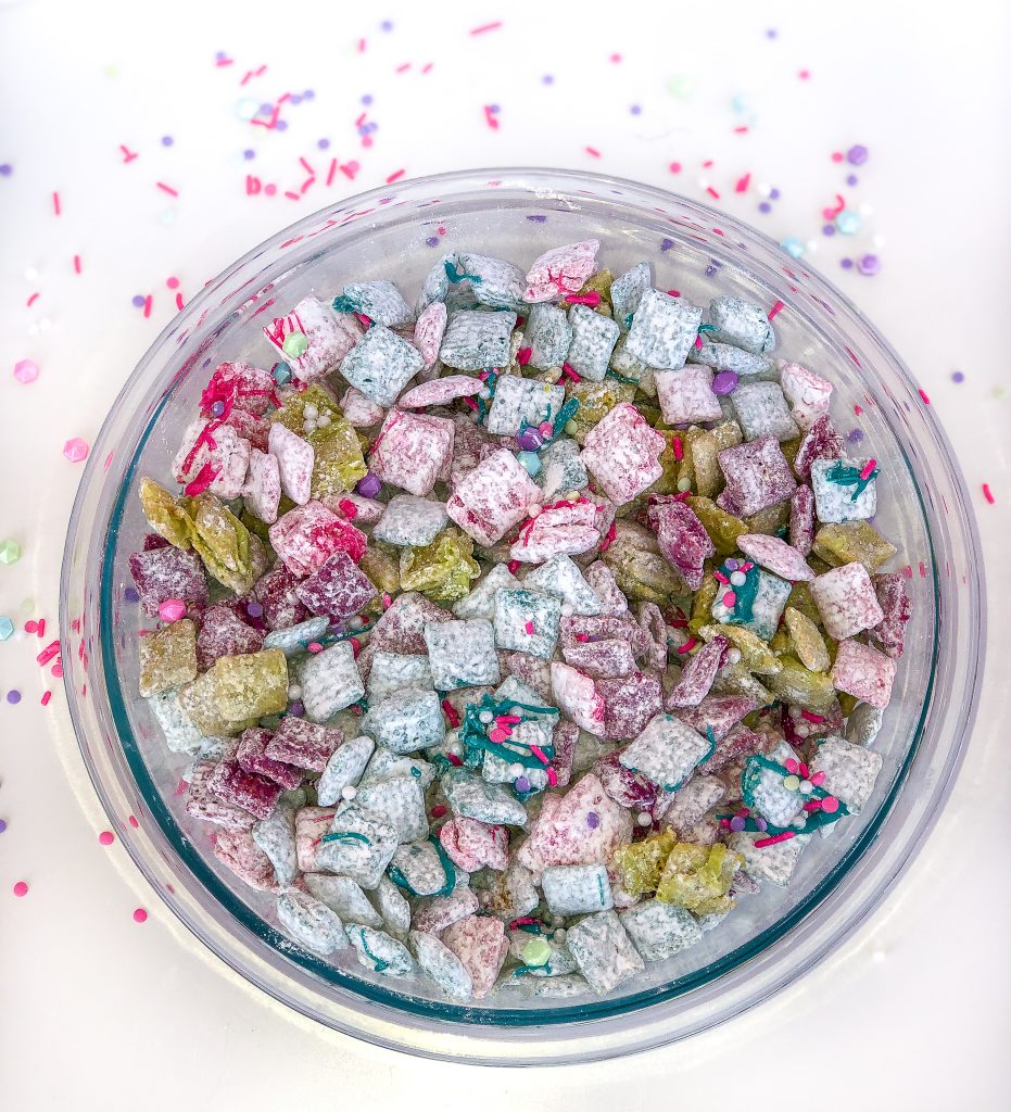 Rainbow Muddy Buddies. Rainbow muddy buddies recipe is perfect for Trolls birthday party, Unicorn birthday party, rainbow birthday party. Trolls birthday party food ideas. Unicorn birthday party food ideas. Rainbow food ideas